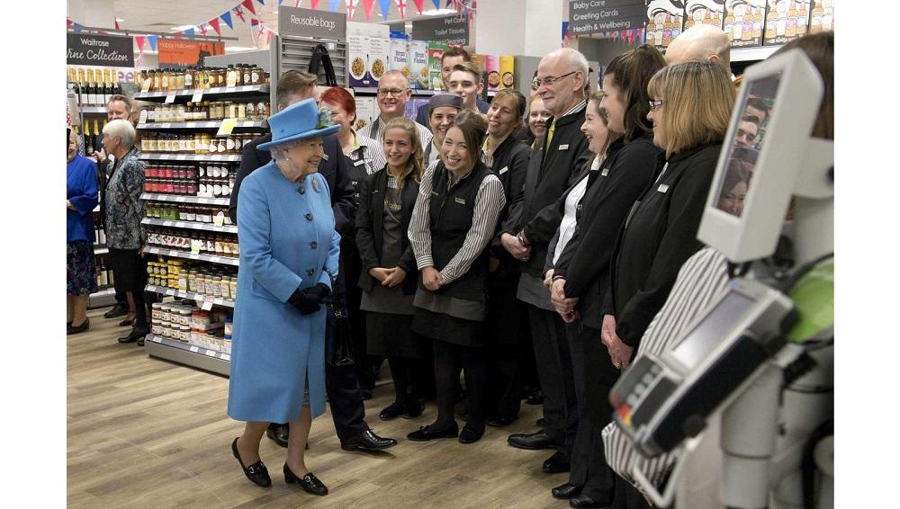 Britain’s Queen Elizabeth meets staff at a Waitrose supermarket during a visit to the town of Poundbury