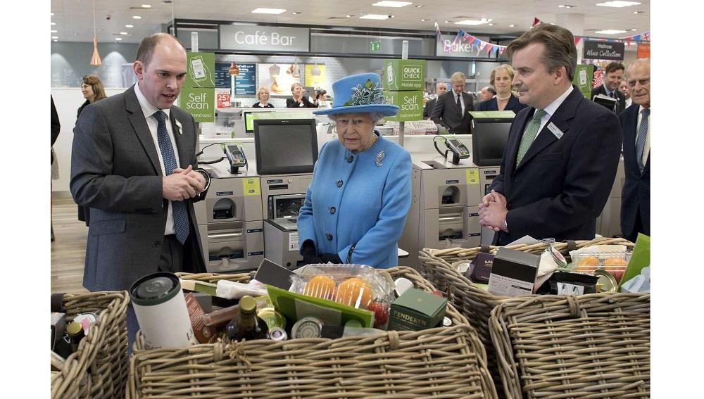 Britain’s Queen Elizabeth looks at food hampers during a visit to a Waitrose supermarket in the town of Poundbury