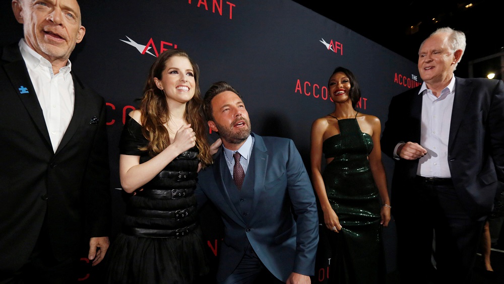 Cast member Affleck poses with co-star Kendrick, as cast members Simmons, Addai-Robinson and Lithgow watch, at the premiere of “The Accountant” at the TCL Chinese theatre in Hollywood
