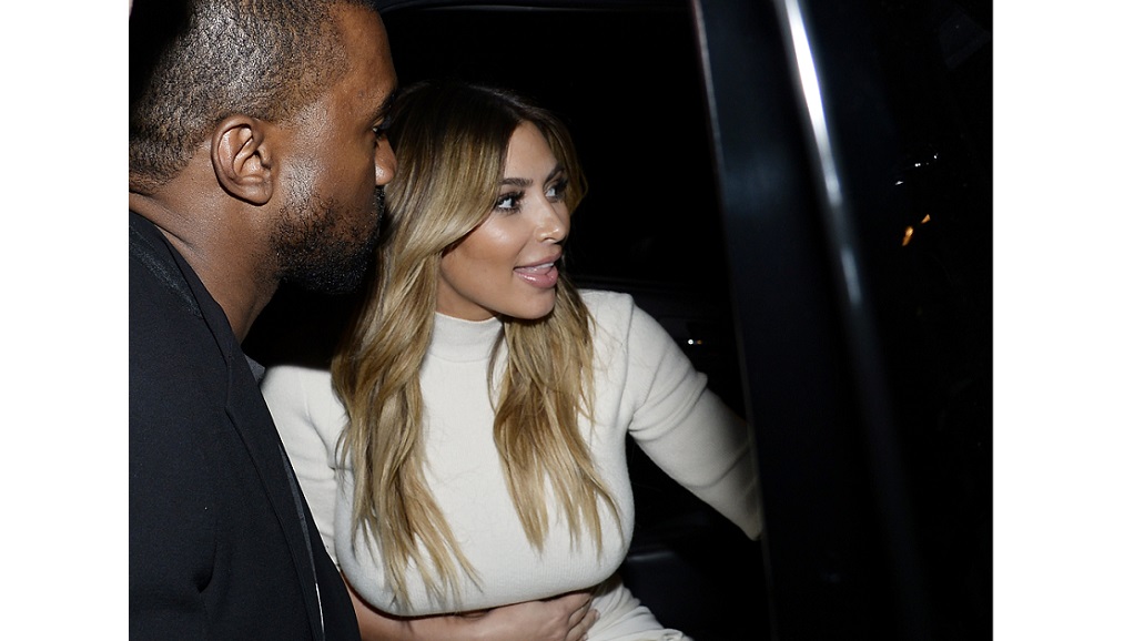 U.S. singer West helps his fiancee Kardashian get out of the wrong limousine they boarded after attending Dream For Future Africa Foundation Inaugural Gala in Beverly Hills