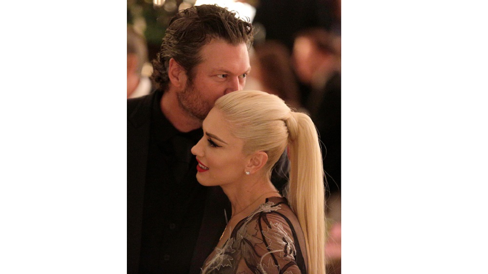 Singer Gwen Stefani receives a kiss from Blake Shelton during a State Dinner at the White House in Washington