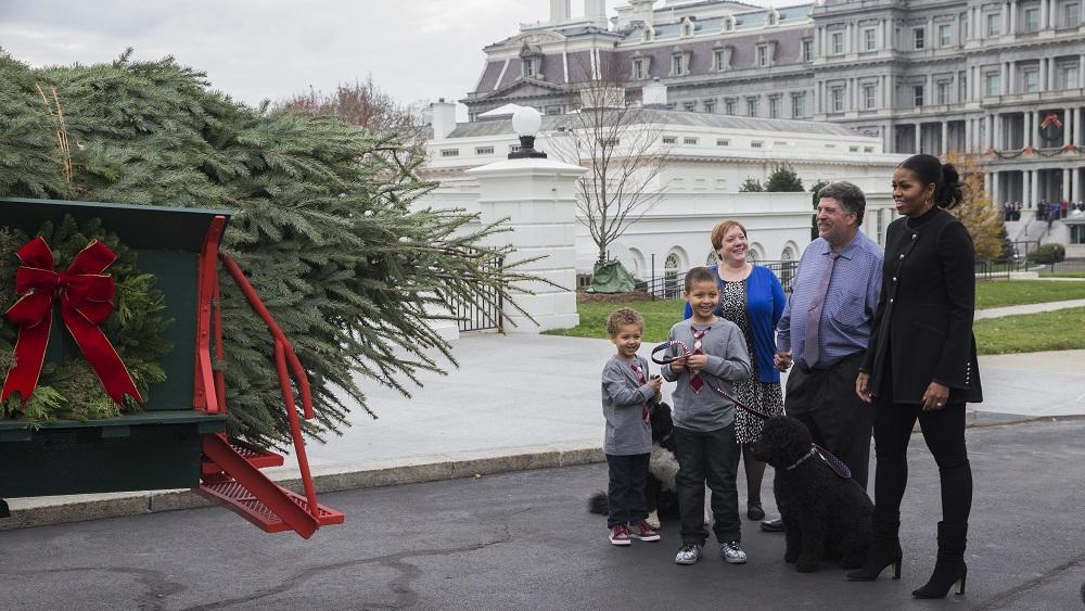 First Lady Michelle Obama welcomes the arrival of the Official White House Christmas Tree