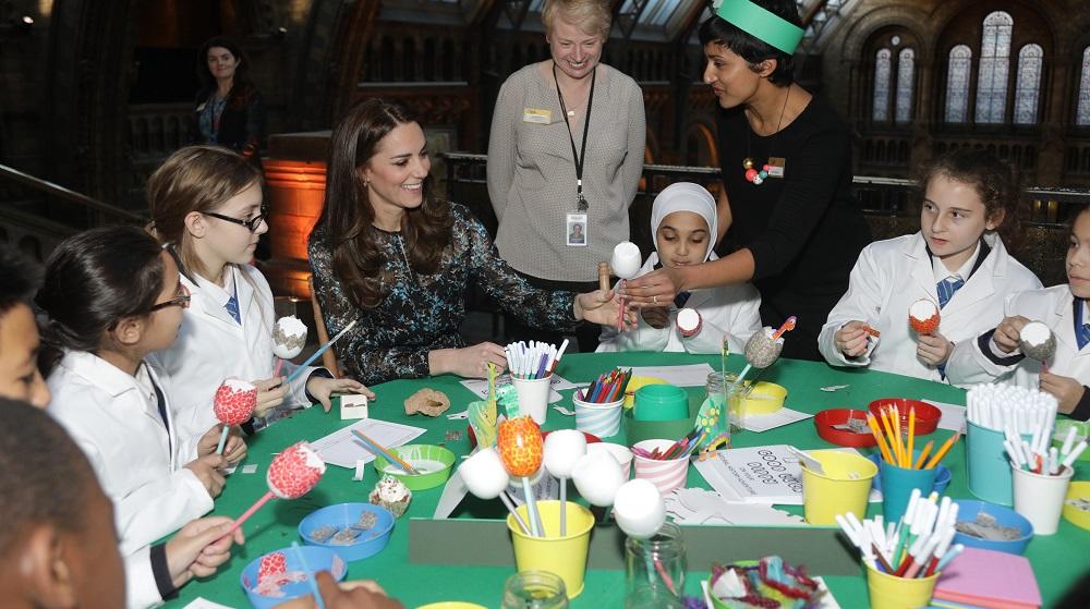 Britain’s Catherine, Duchess of Cambridge makes a dinosaur egg whilst attending a children’s tea party  to celebrate Dippy the Diplodocus’s time in Hintze Hall with pupils from Oakington Manor Primary School, at the Natural History Museum in London