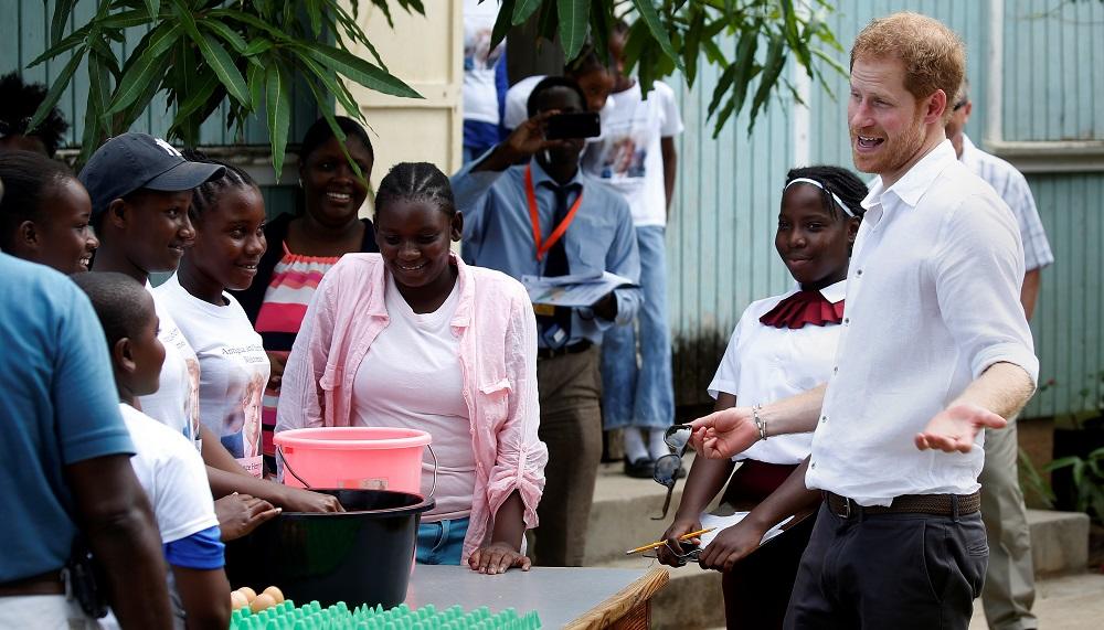 Prince Harry tours a high school during his official visit to Codrington