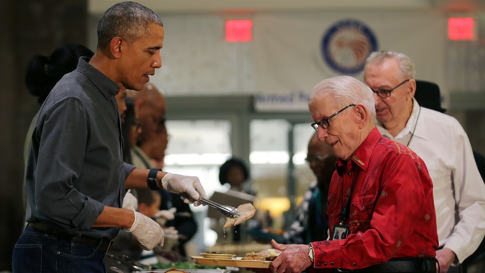 U.S. President Barack Obama serves Thanksgiving dinner to residents of the Armed Forces Retirement Home (AFRH) in Washington, U.S.