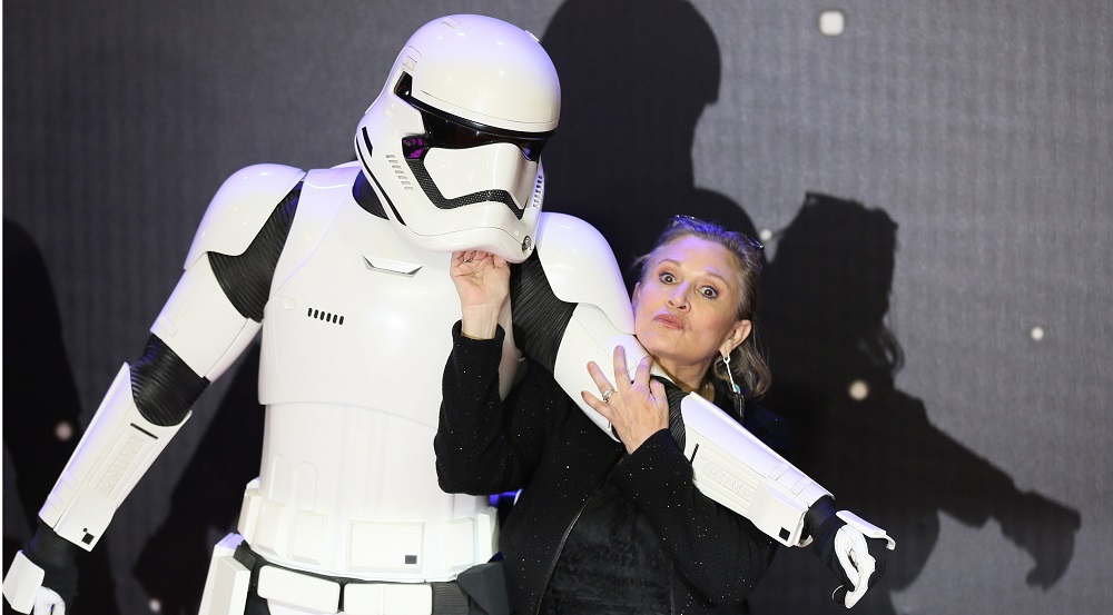 Carrie Fisher  poses for cameras as she arrives at the European Premiere of Star Wars, The Force Awakens in Leicester Square, London