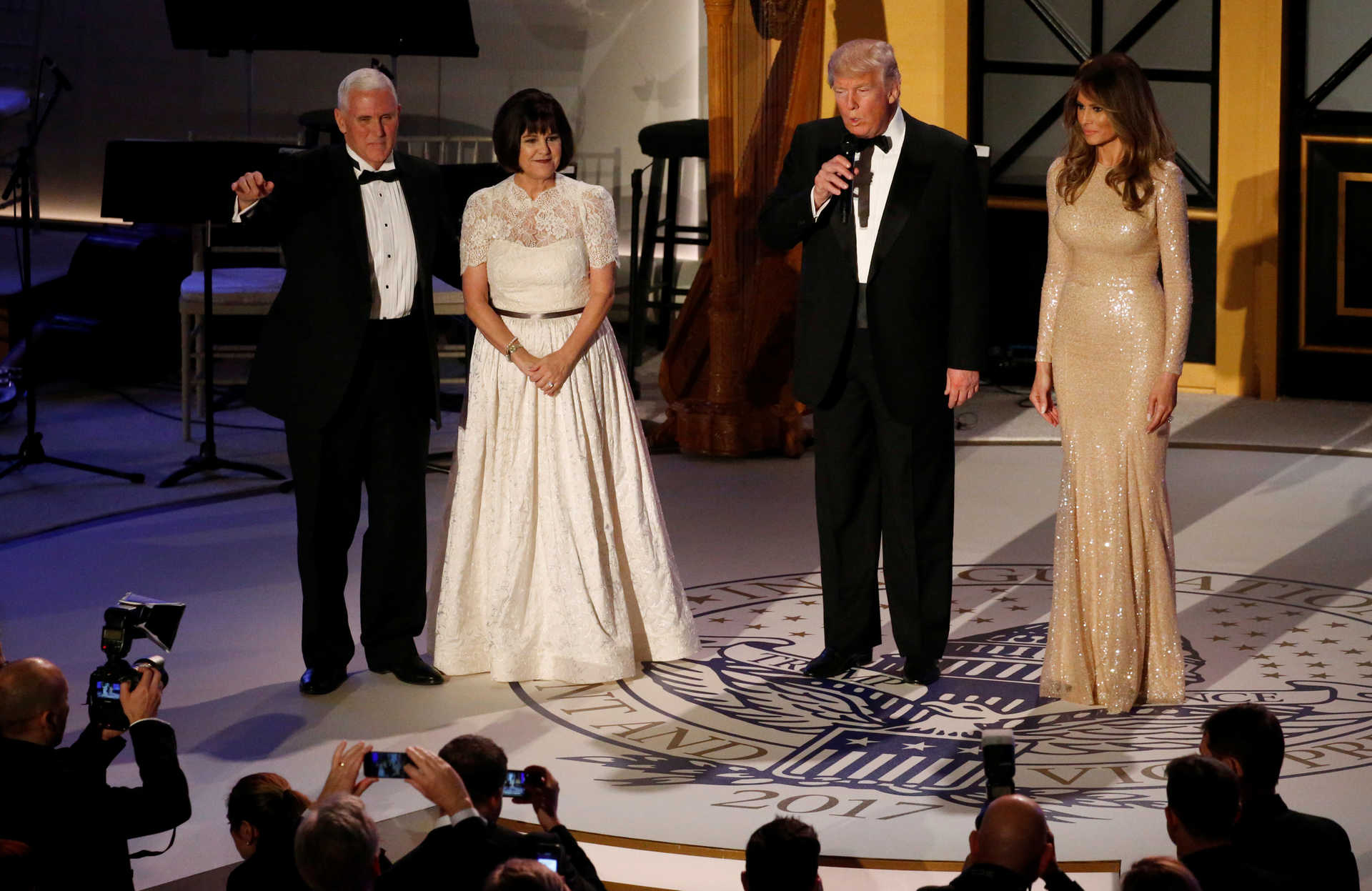 Trump and his wife take the stage with Pence and his wife Karen at a pre-inauguration candlelight dinner with supporters at Union Station in Washington