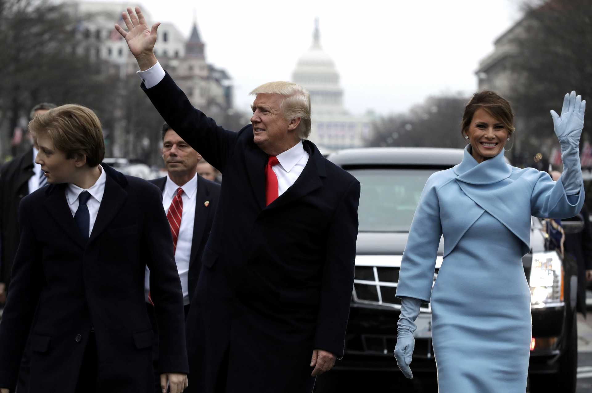 President Donald Trump waves as he walks with first lady Melania Trump in Washington