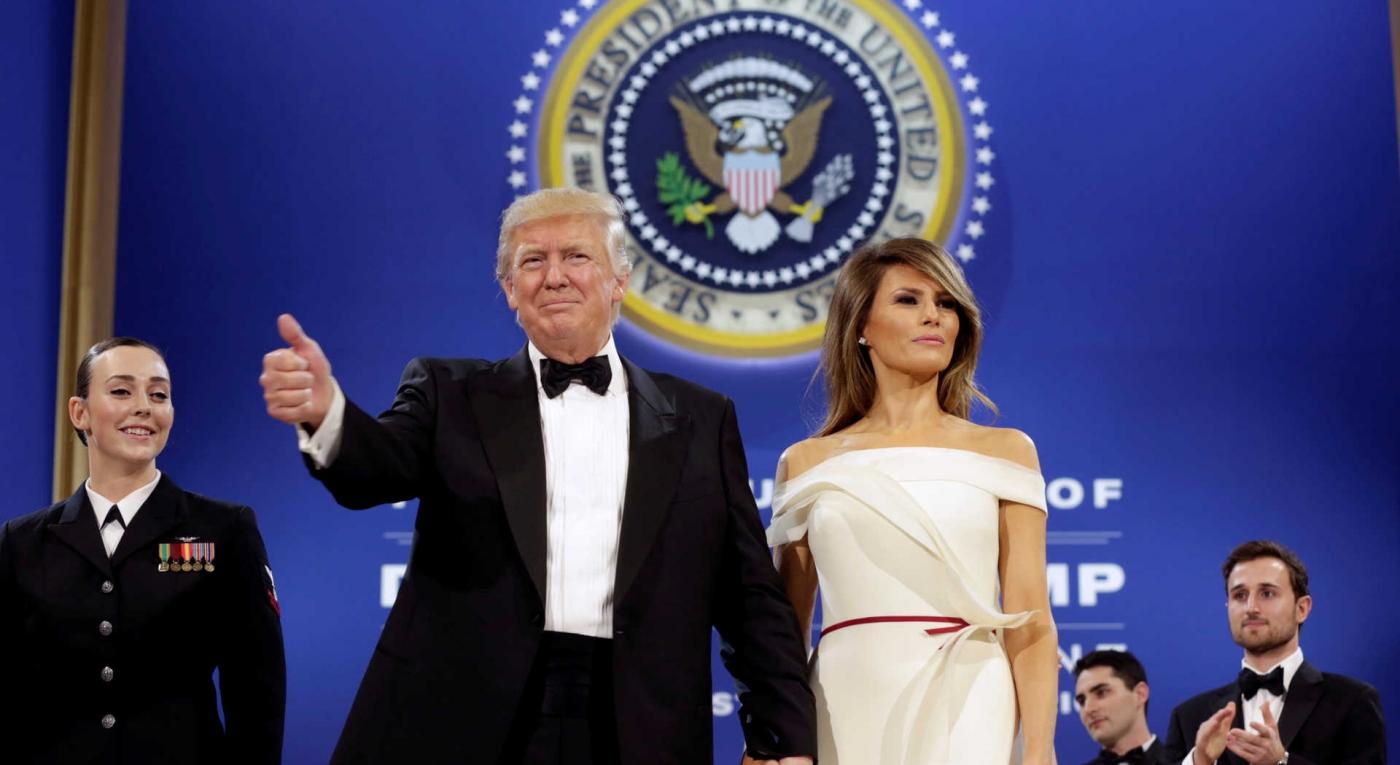 President Donald Trump salutes with his wife Melania
