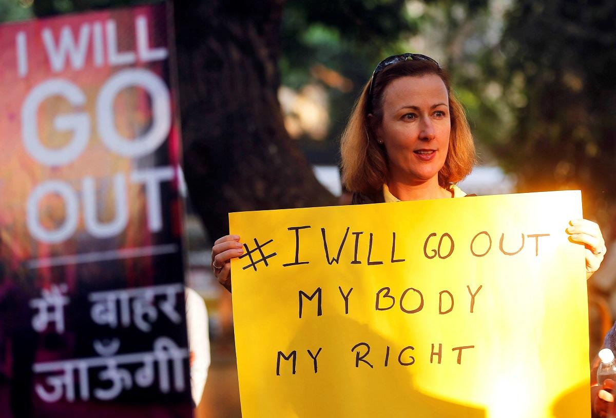 A woman holds a sign as she takes part in the #IWillGoOut rally, to show solidarity with the Women’s March in Washington, along a street in Mumbai