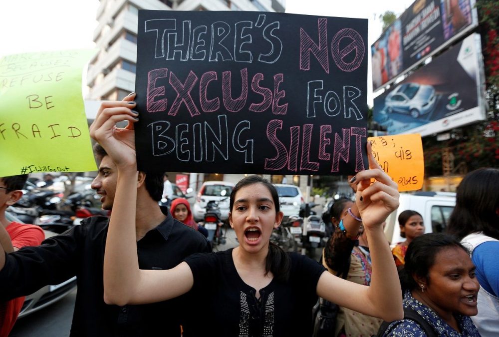 A woman shouts slogans as she takes part in the #IWillGoOut rally, to show solidarity with the Women’s March in Washington, along a street in Ahmedabad