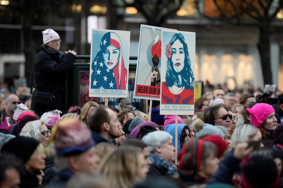 Protesters carrying banners and placards take part in a Women’s March in Stockholm, Sweden