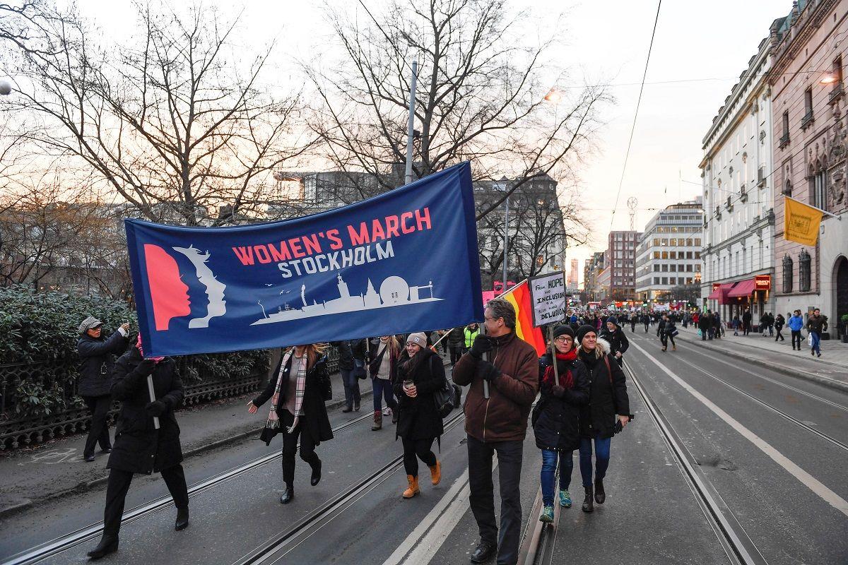 Protesters carrying banners and placards take part in a Women’s March in Stockholm, Sweden