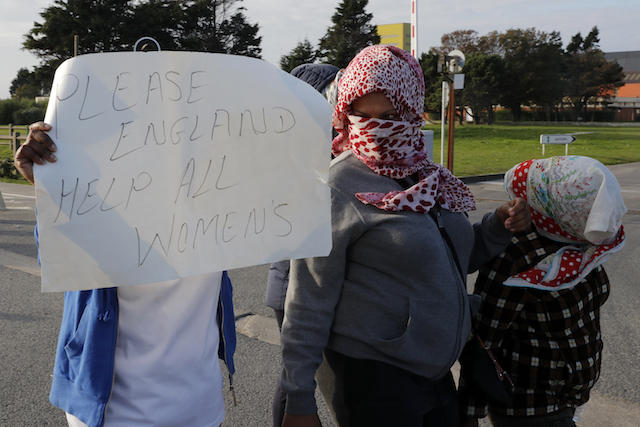 Migrant women demonstrate on the second day of their evacuation and transfer to reception centers in France, as part of the dismantlement of the Jungle in Calais