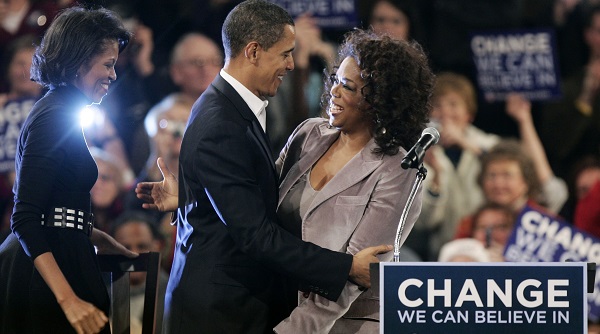 U.S. Democratic presidential candidate Obama greets entertainer and talk show host Winfrey as his wife Michelle looks on at a rally in Des Moines