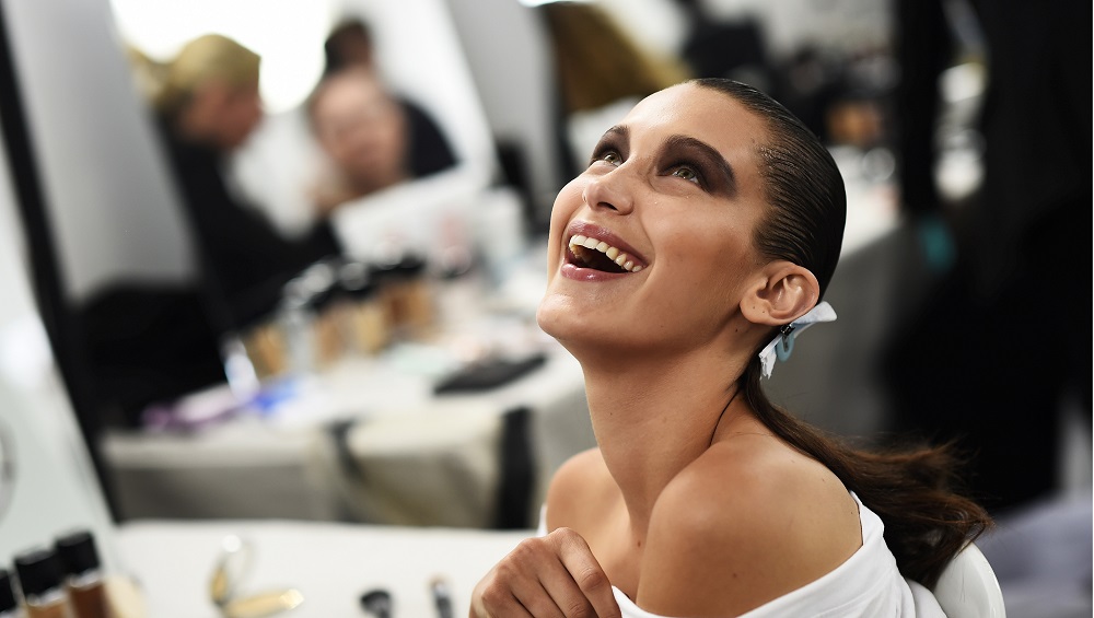 Model Bella Hadid smiles as she has her make-up applied inside Blenheim Palace ahead of a Dior fashion show in Woodstock