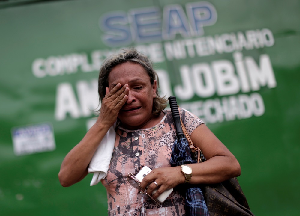 A relative of a prisoner reacts in front of the main entrance of Anisio Jobim prison in Manaus
