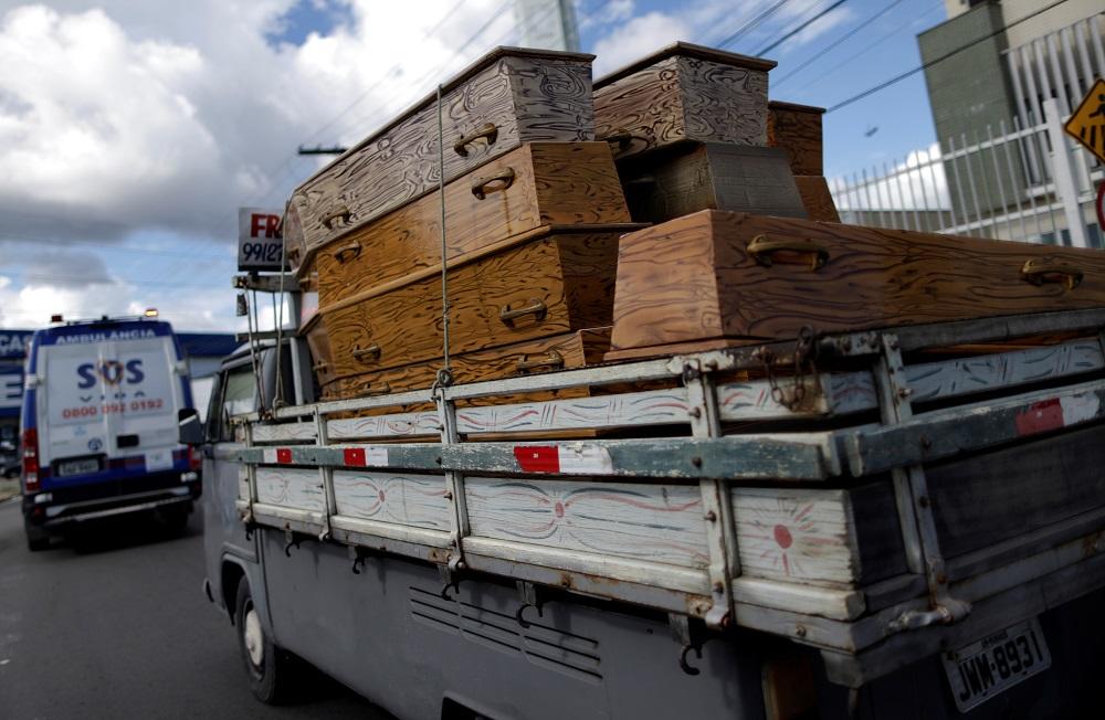 A car carrying coffins is picture in the Amazon jungle city of Manaus