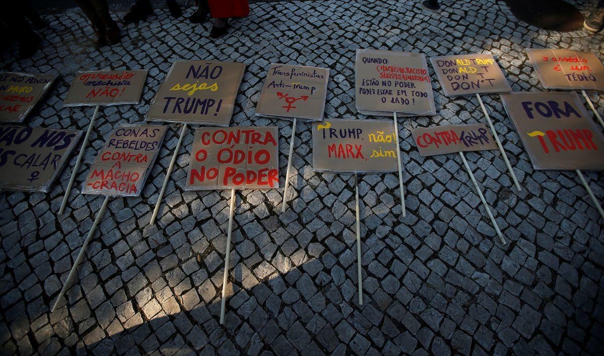 Placards are seen before a protest against U.S. President Donald Trump next to the U.S. embassy during the Women’s March in Lisbon