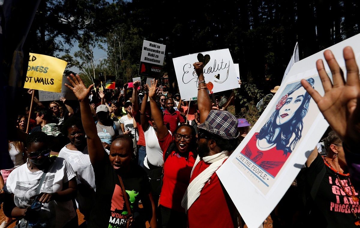 Demonstrators chant slogans and hold banners in protest against U.S. President Donald Trump during the Women’s March inside Karura forest in Kenya’s capital Nairobi