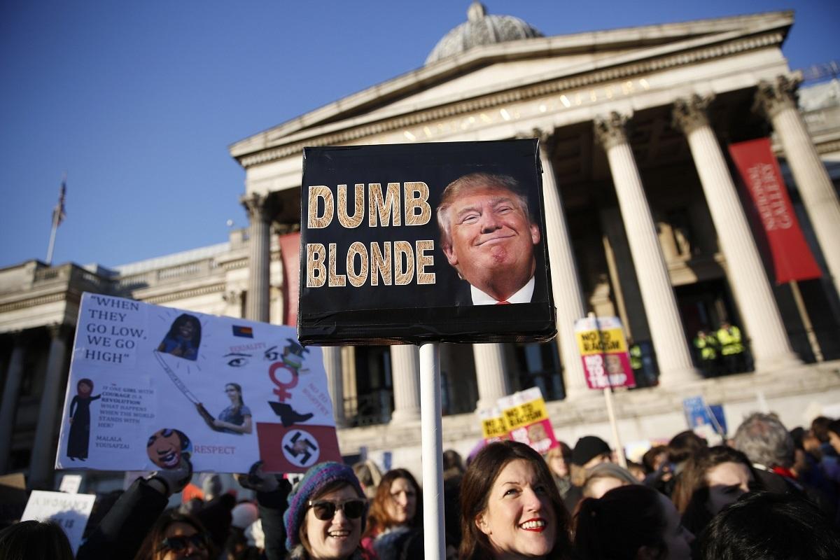 Protesters carrying banners take part in the Women’s March on London, as they stand in Trafalgar Square, in central London