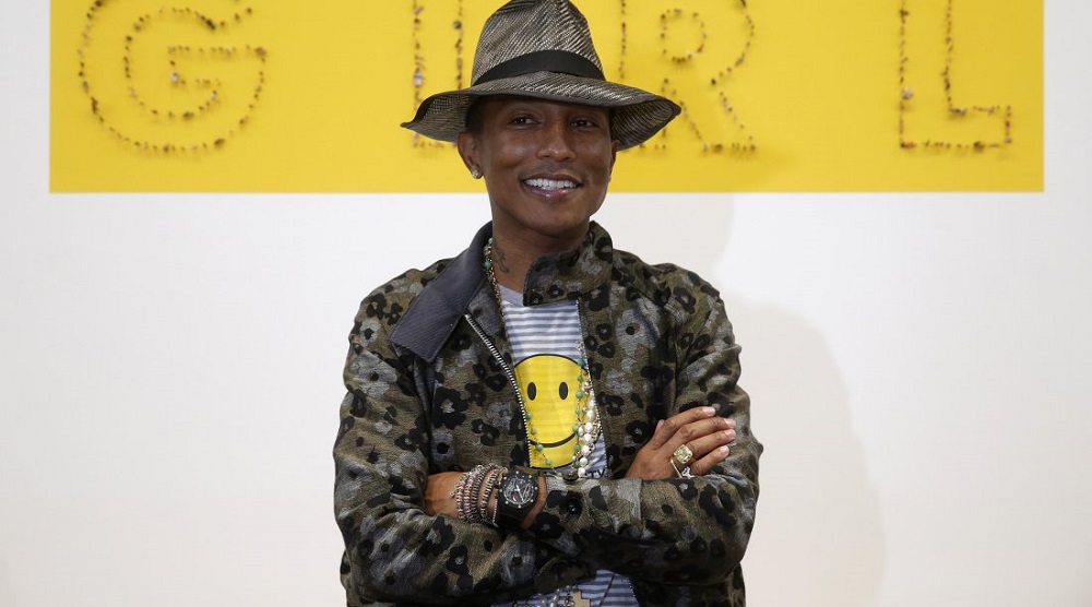 Singer Pharrell Williams poses during the opening of the exhibition “GIRL” at the Galerie Perrotin in Paris