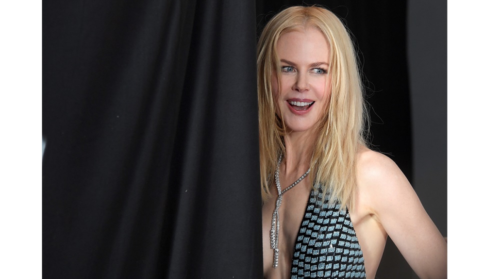 Presenter Nicole Kidman stands behind a screen as she waits to be photographed at the British Academy of Film and Television Awards (BAFTA)