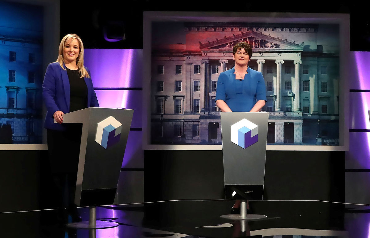 Leaders of political parties in Northern Ireland O'Neill of Sinn Fein and Foster of the DUP pose before a television debate ahead of the forthcoming Northern Ireland Assembly elections in Belfast