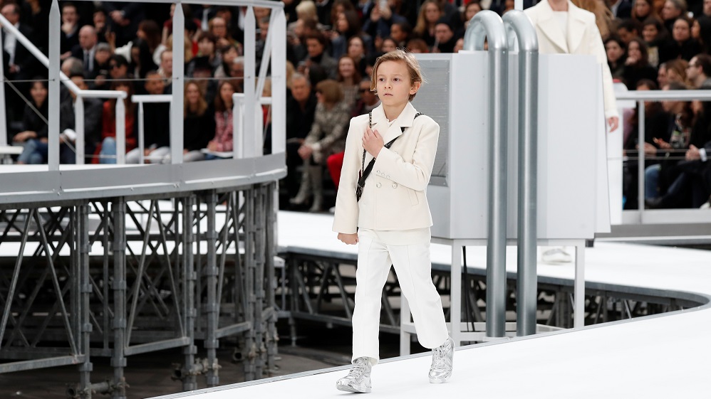 Model Hudson Kroenig presents a creation by German designer Karl Lagerfeld as part of his Fall/Winter 2017-2018 women’s ready-to-wear collection for fashion house Chanel during Fashion Week in Paris