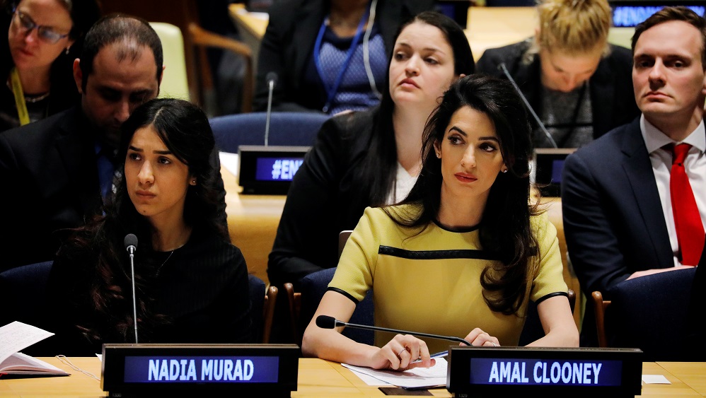 International human rights lawyer Amal Clooney sits with Nadia Murad as she waits to address a Bringing Daesh to Justice event at United Nations headquarters in New York