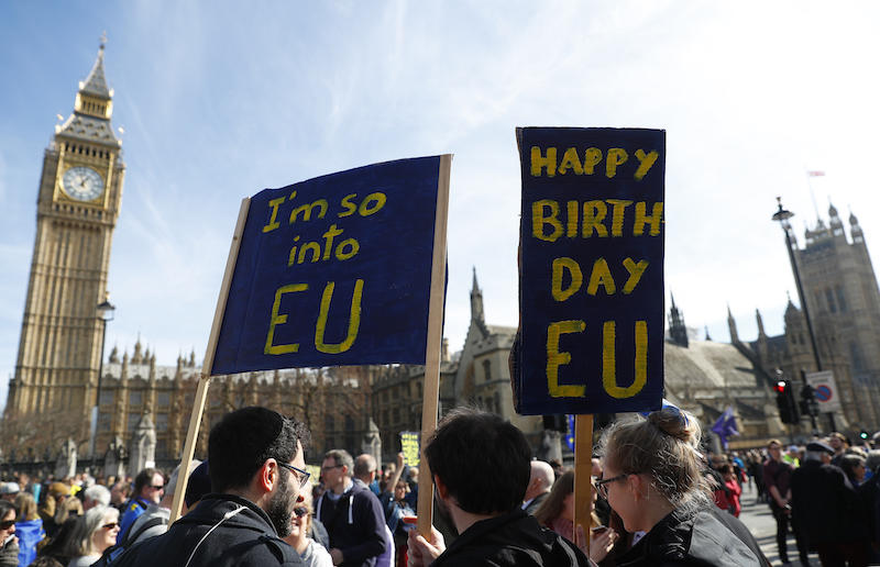 Demonstrators hold a banner in Parliament Square as they take part in a Unite for Europe march, in central London