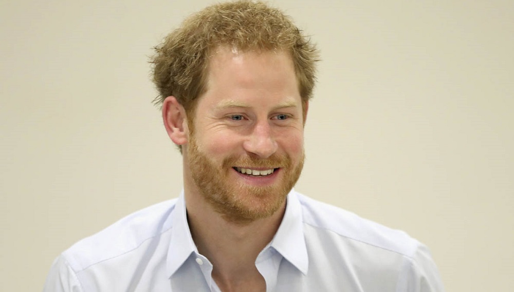 Prince Harry chats with staff during his visit to the Burrell Street Sexual Health Clinic in London