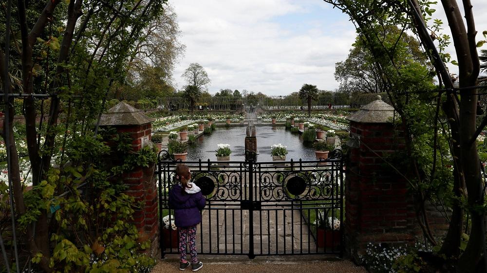 A girl looks at the Princess Diana memorial garden at Kensington Palace in London