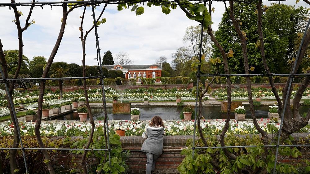 A girl looks at the Princess Diana memorial garden at Kensington Palace in London