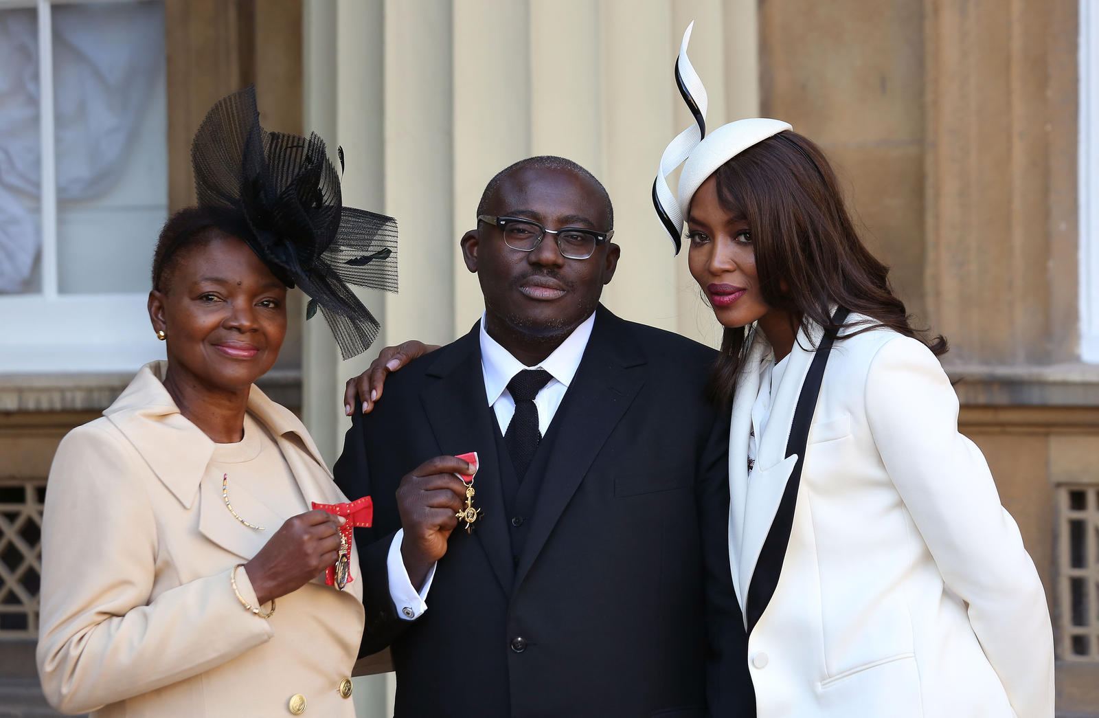 Model Naomi Campbell poses for a photograph with Baroness Amos and fashion stylist Edward Enninful, at Buckingham Palace in London