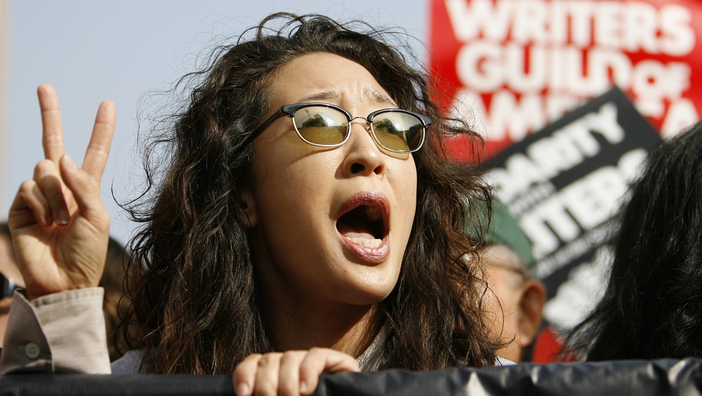 Sandra Oh chants along with striking members of the Writers Guild of America, West during a rally in Hollywood