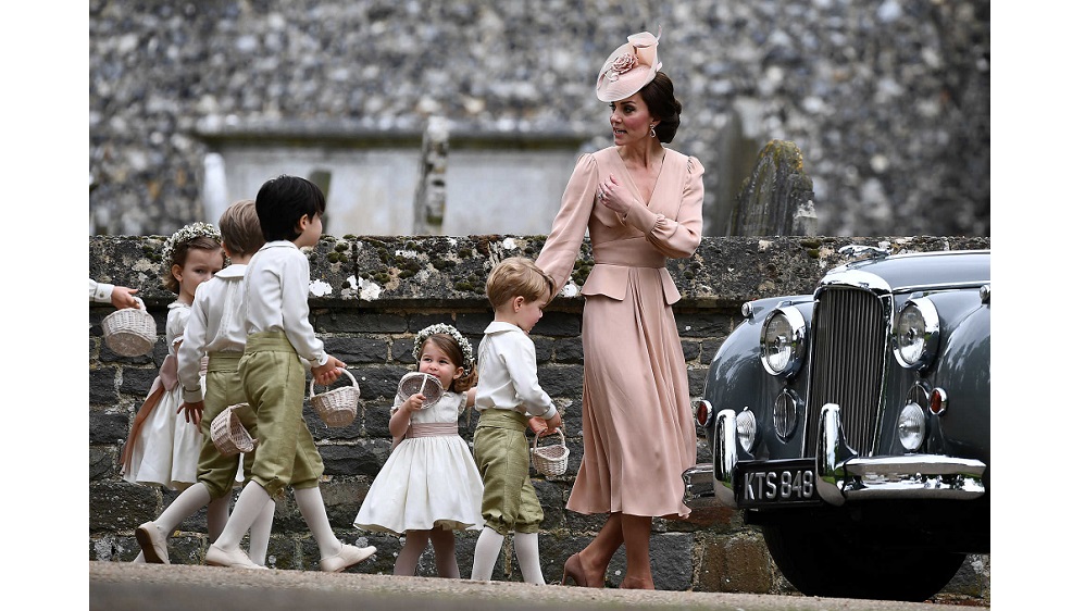 Britain’s Catherine, Duchess of Cambridge walks with the flower boys and girls, including Prince George and Princess Charlotte after the wedding of Pippa Middleton and James Matthews at St Mark’s Church in Englefield,