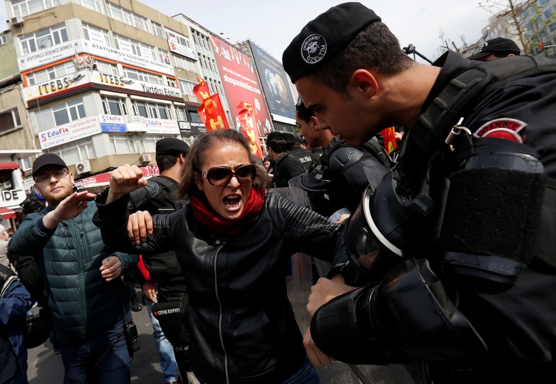 Turkish riot police scuffle with a group of protesters as they attempted to defy a ban and march on Taksim Square to celebrate May Day in Istanbul