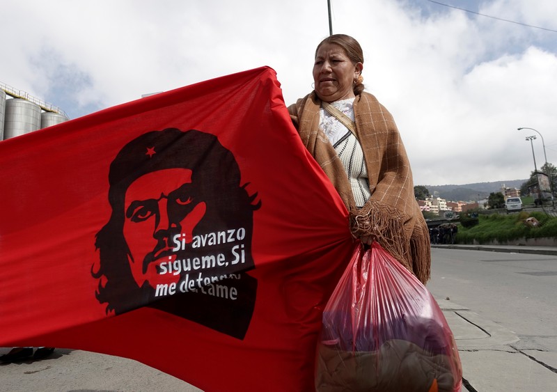 A retailer of second hand clothes attends a rally during May Day celebrations in La Paz