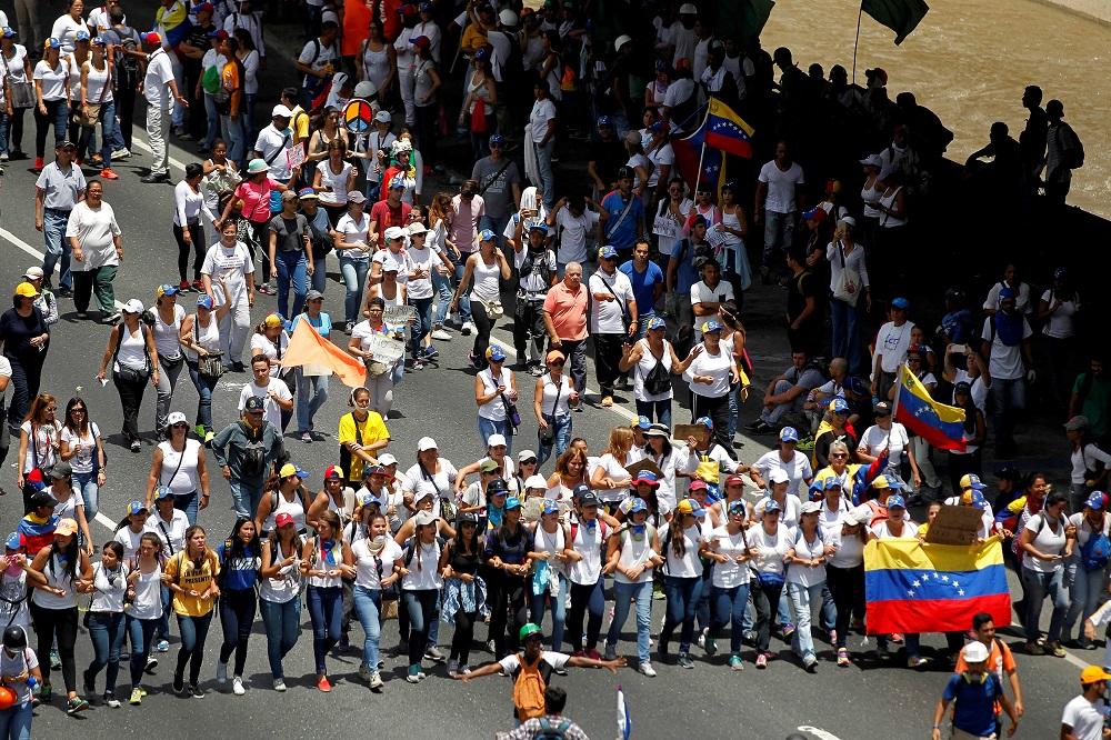 Demonstrators attend a women’s march to protest against President Nicolas Maduro’s government in Caracas