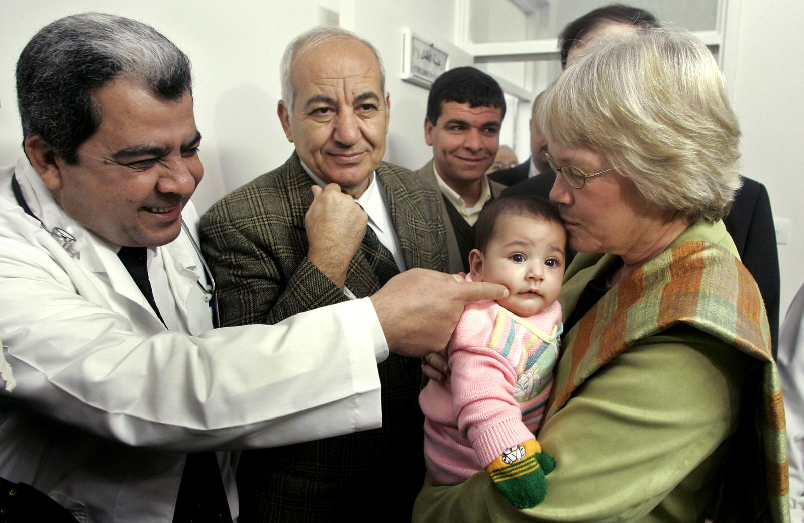 UNRWA general commissioner Karen Abuzayd holds a baby during her visit to Shati hospital in Shati refugee camp in Gaza