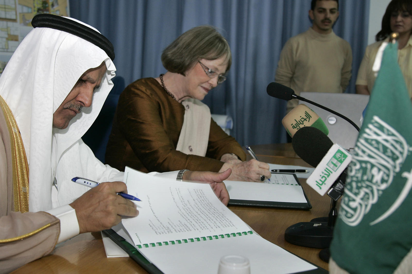 AbuZayd, head of the UNRWA, and Bassam, vice chairman of the Saudi Fund, sign a donation agreement in Amman