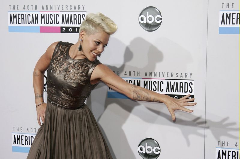Singer Pink poses as she arrives at the 40th American Music Awards in Los Angeles