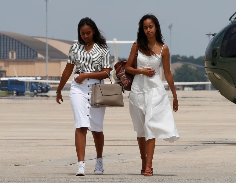 Obama’s daughters Sasha and Malia arrive with their parents to board Air Force One for travel to Massachusetts for their annual vacation at Martha’s Vineyard, from Joint Base Andrews, Maryland, U.S.
