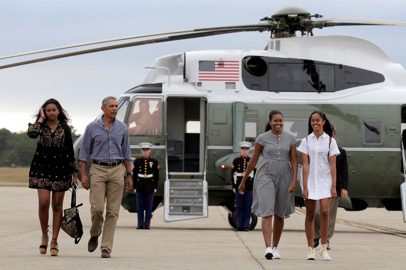 U.S. President Barack Obama, U.S. first lady Michelle Obama and their daughters Malia and Sasha board Air Force One at Cape Cod Coast Guard Air Station in Buzzards Bay, Massachusetts