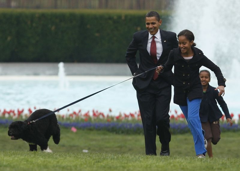 U.S. President Obama runs with daughters and new pet dog Bo on the South Lawn at the White House in Washington