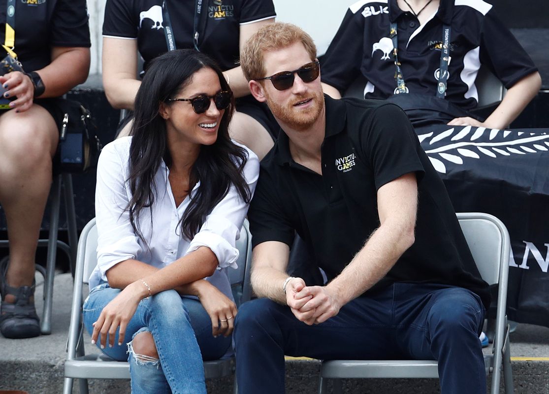 Britain’s Prince Harry sits with girlfriend actress Markle to watch a wheelchair tennis event during the Invictus Games in Toronto