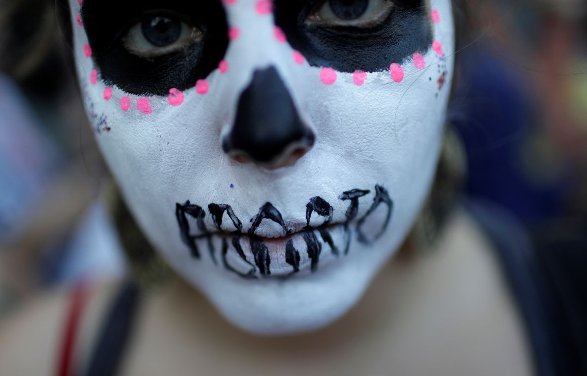 A woman demonstrates against Brazil’s congressional move to criminalize all cases of abortion, including cases of rape and where the mother’s life is in danger, with a face painting representing a woman dead after an illegal abortion, in Rio de Janeiro