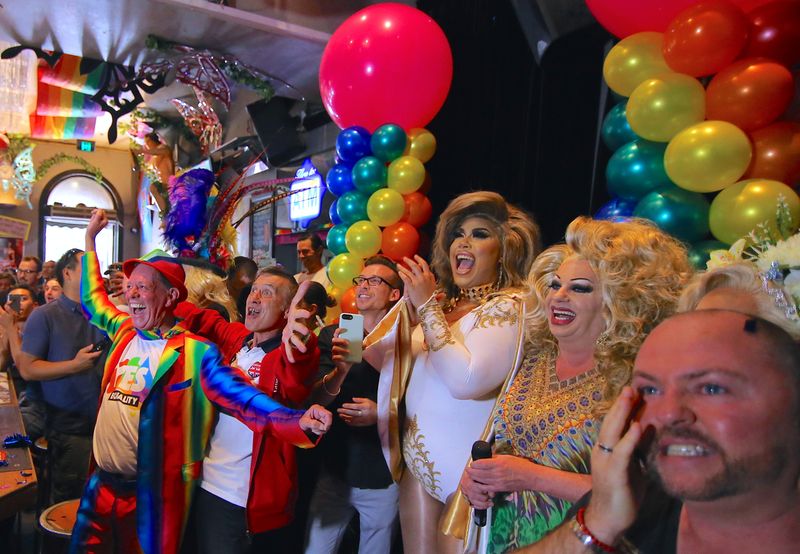 Members of the Sydney’s gay community react as they celebrate after it was announced the majority of Australians support same-sex marriage in a national survey, at a pub located on Sydney’s Oxford street