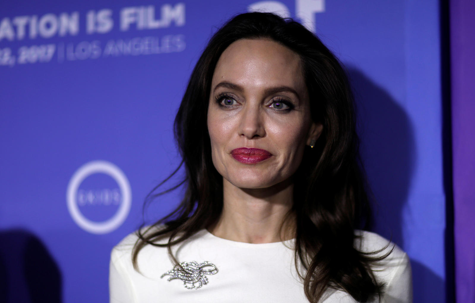 Producer Jolie poses at the premiere for 